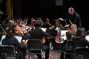 conductor in concert with youth orchestra
